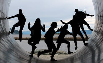 Group of teens in silhouette.