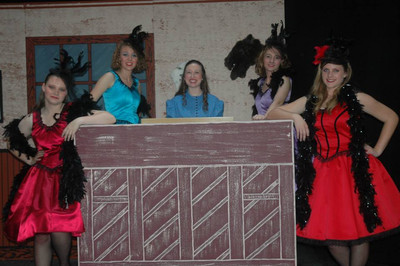 Melody Plunkett surrounded by the Saloon Girls